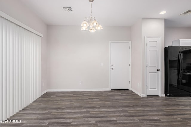 interior space with a notable chandelier and dark hardwood / wood-style flooring