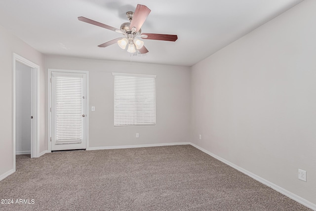 spare room with ceiling fan and light colored carpet