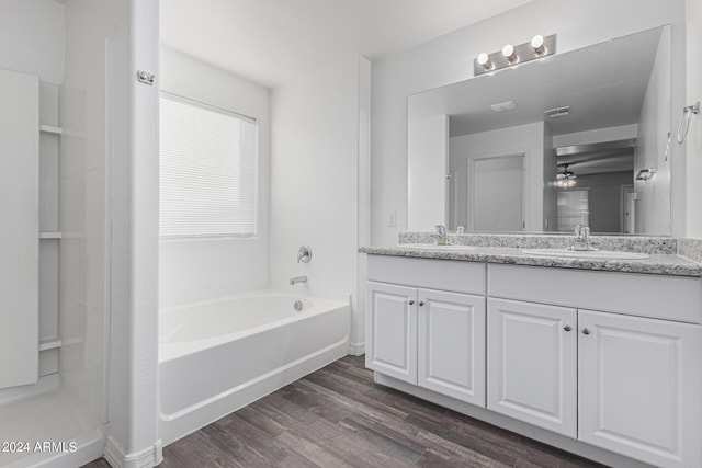 bathroom featuring ceiling fan, vanity, wood-type flooring, and shower with separate bathtub