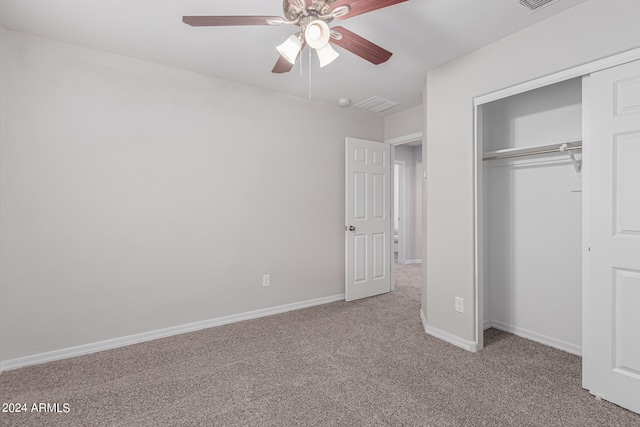 unfurnished bedroom featuring light carpet, ceiling fan, and a closet