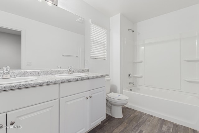 full bathroom with wood-type flooring, vanity, toilet, and shower / washtub combination