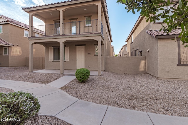 view of front of home with a balcony and a patio area