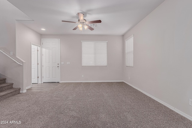 carpeted spare room with ceiling fan