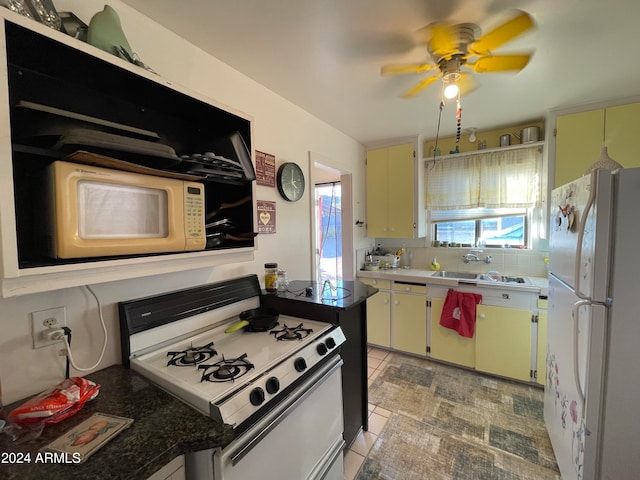 kitchen with sink, light tile patterned flooring, tasteful backsplash, white appliances, and ceiling fan