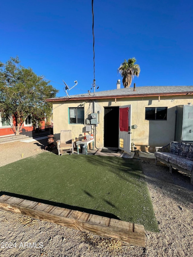 rear view of house featuring a yard and a patio area