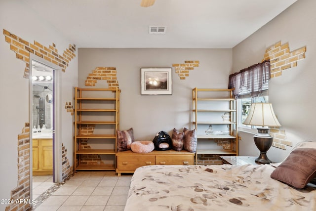 tiled bedroom featuring ensuite bathroom