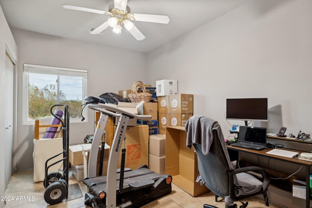 tiled home office featuring a ceiling fan