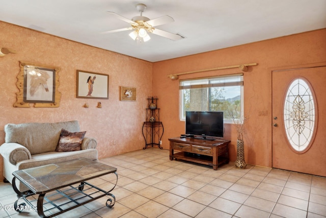 tiled living room with ceiling fan