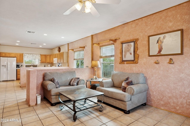 living room with ceiling fan and light tile patterned floors