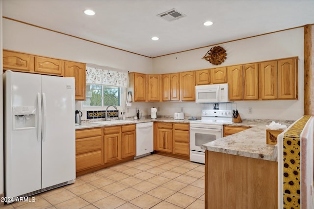 kitchen featuring light stone counters, sink, white appliances, and light tile patterned flooring