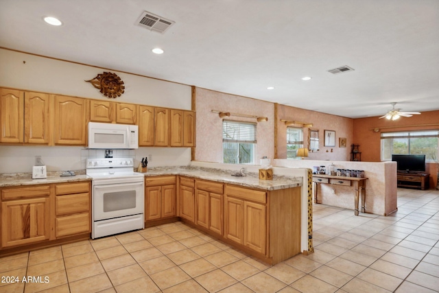 kitchen featuring light tile patterned floors, white appliances, light stone counters, kitchen peninsula, and ceiling fan