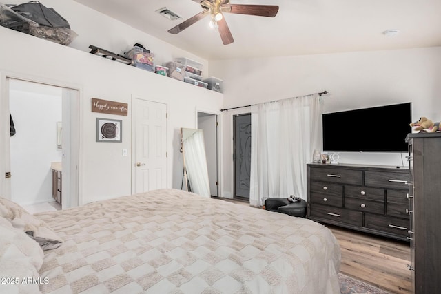 bedroom featuring ceiling fan, visible vents, and light wood-style floors