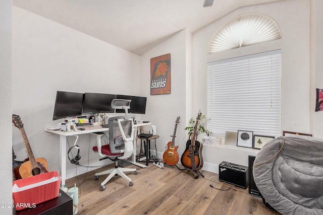 home office with baseboards, vaulted ceiling, and wood finished floors