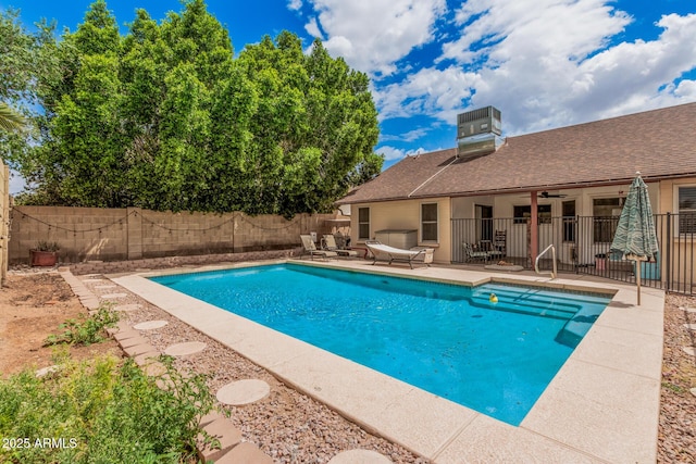 view of swimming pool featuring a fenced backyard, a patio, a fenced in pool, and cooling unit