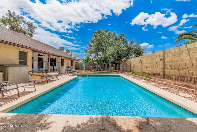 view of swimming pool featuring a fenced backyard, a patio, a fenced in pool, and a ceiling fan