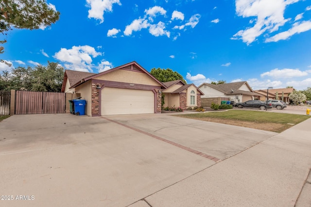 ranch-style house featuring driveway, brick siding, fence, a garage, and stucco siding
