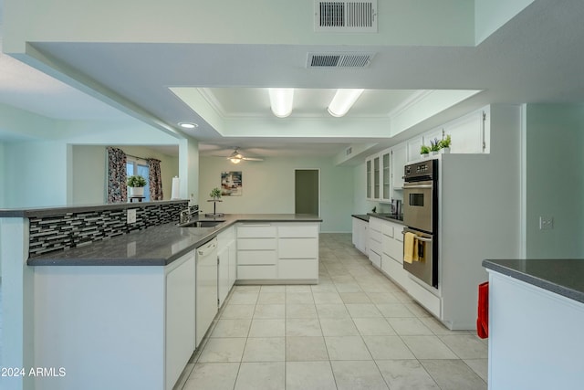 kitchen featuring kitchen peninsula, white cabinets, white dishwasher, and ceiling fan