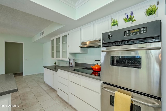 kitchen featuring black electric stovetop, white cabinetry, a textured ceiling, light tile patterned flooring, and stainless steel double oven