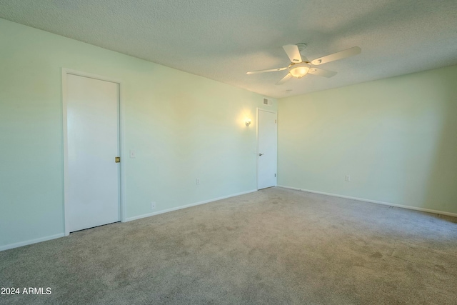 carpeted empty room with a textured ceiling and ceiling fan