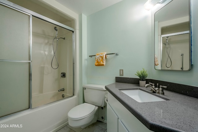 full bathroom featuring combined bath / shower with glass door, tile patterned floors, vanity, and toilet