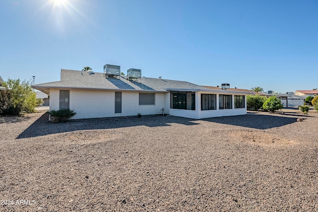 back of property featuring a sunroom and cooling unit