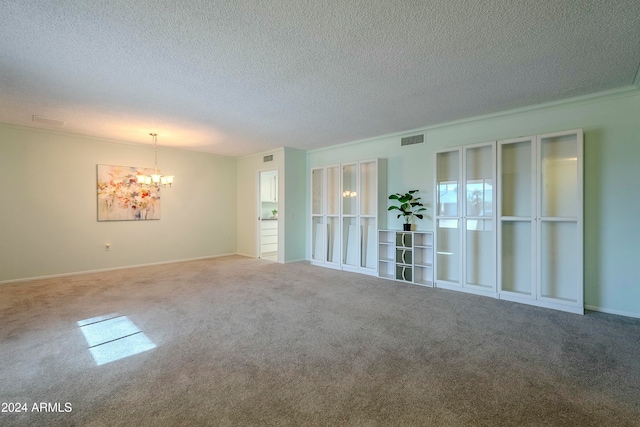 unfurnished room featuring carpet, a textured ceiling, and a chandelier