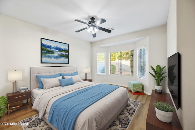 bedroom with ceiling fan and light hardwood / wood-style flooring