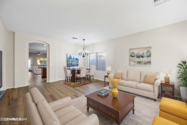 living room featuring a chandelier and hardwood / wood-style flooring