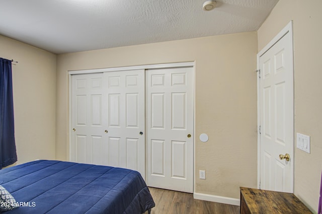 274 S 18th St, Coolidge, AZ 85128 - bedroom with a closet, dark wood-type flooring, and a textured ceiling