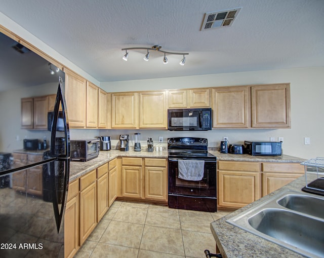 274 S 18th St, Coolidge, AZ 85128 - kitchen with light brown cabinets, black appliances, sink, light tile patterned floors, and a textured ceiling