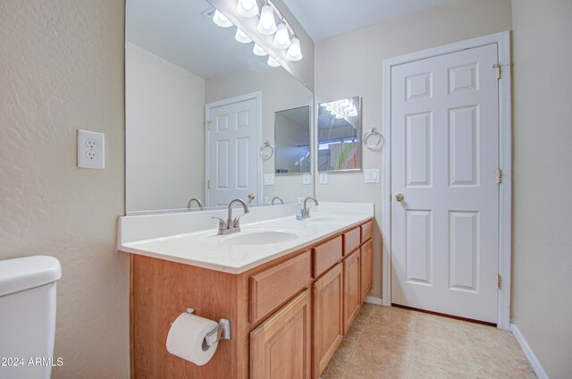 274 S 18th St, Coolidge, AZ 85128 - bathroom with tile patterned floors, vanity, and toilet