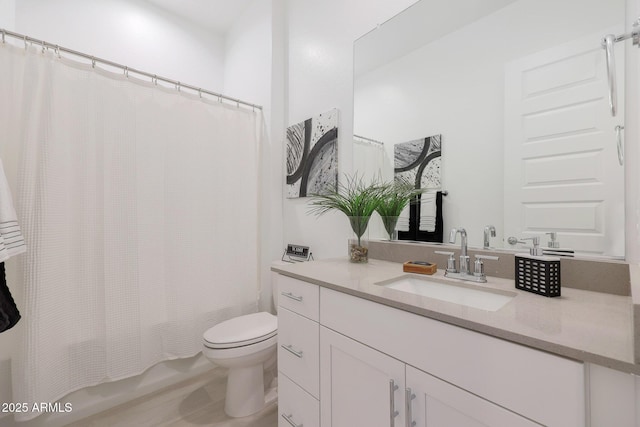 full bathroom with vanity, shower / bath combo with shower curtain, and toilet