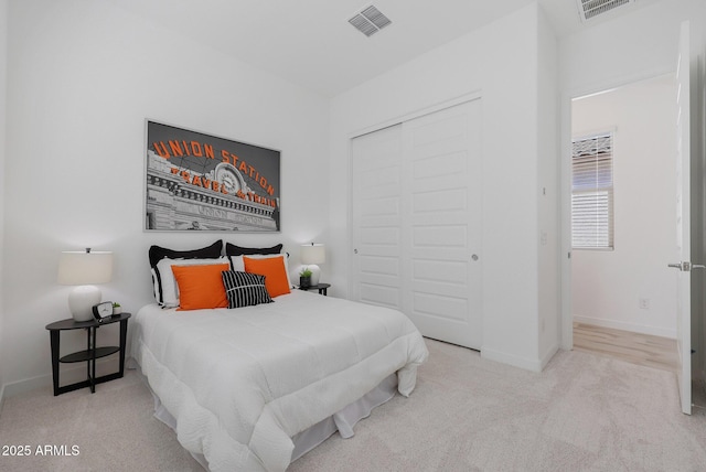 bedroom with light colored carpet and a closet