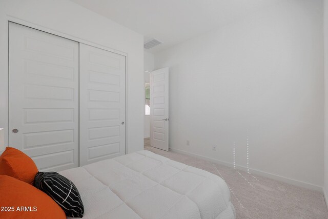 carpeted bedroom with a closet