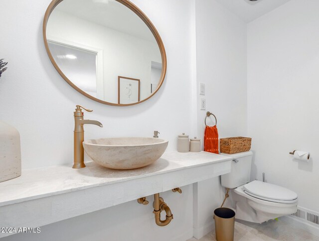 bathroom featuring sink and toilet