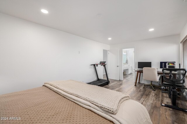 bedroom with hardwood / wood-style flooring and ensuite bath