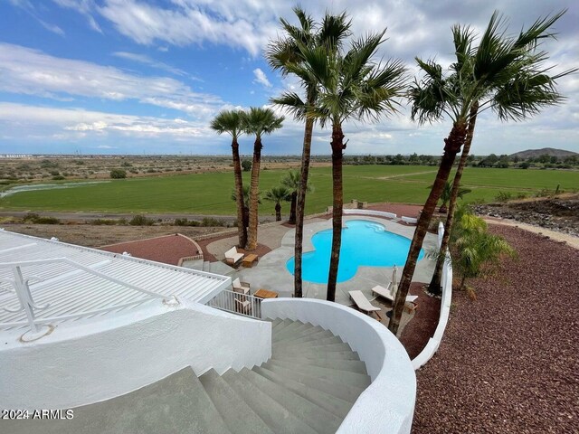 view of pool featuring a patio area and a lawn