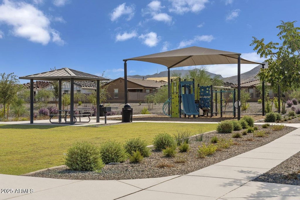 view of property's community with a playground, a gazebo, and a yard