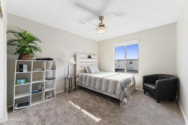 carpeted bedroom with a ceiling fan and baseboards