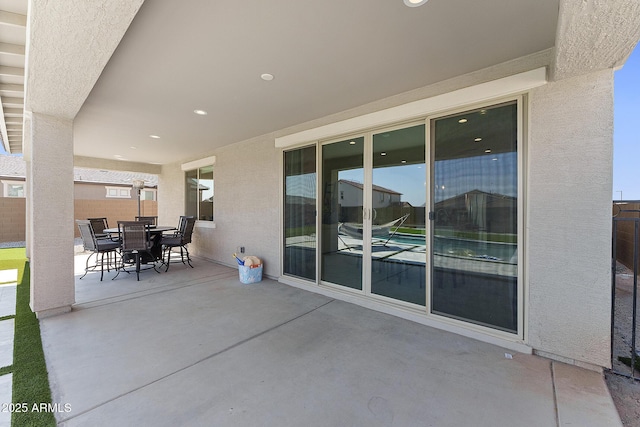 view of patio / terrace with outdoor dining space and fence