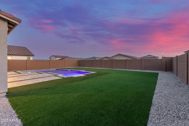 view of yard with a fenced backyard, a fenced in pool, and a patio