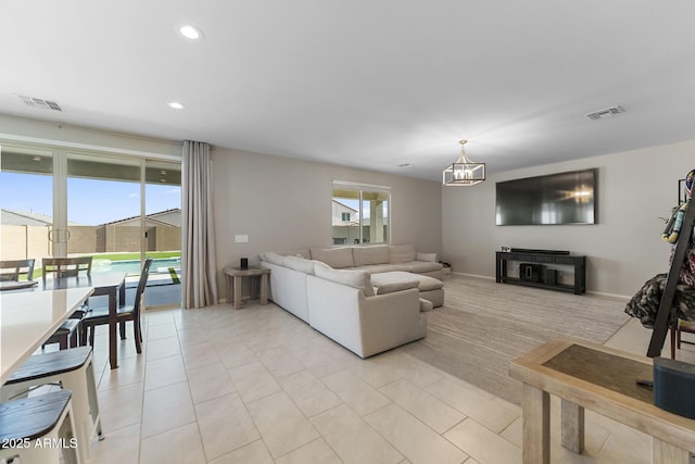 living room featuring recessed lighting, visible vents, a notable chandelier, and light tile patterned flooring