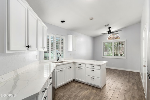 2015 E Glenhaven Dr, Phoenix, AZ 85048 - kitchen featuring a sink, a peninsula, ceiling fan, white cabinets, and wood finished floors