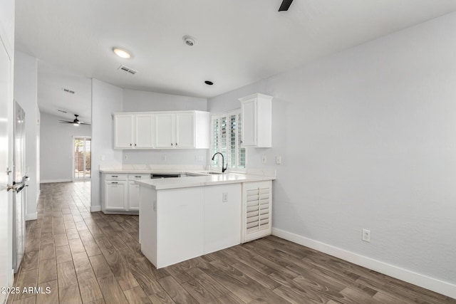 2015 E Glenhaven Dr, Phoenix, AZ 85048 - kitchen featuring a sink, baseboards, a peninsula, dark wood-type flooring, and vaulted ceiling