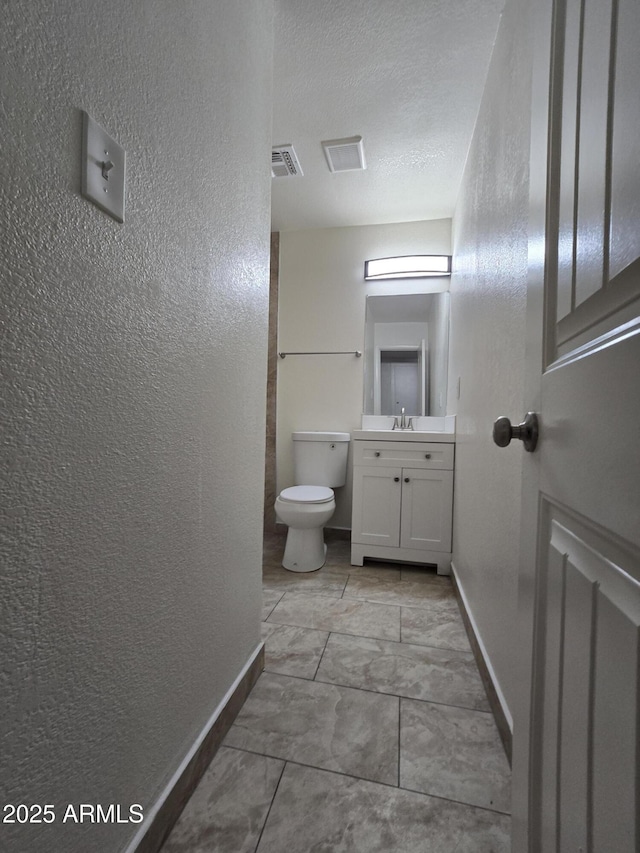 4911 W Merrell St, Phoenix, AZ 85031 - bathroom with a textured wall, vanity, and a textured ceiling