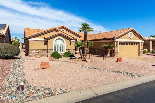 ranch-style house featuring a garage, stone siding, concrete driveway, and stucco siding