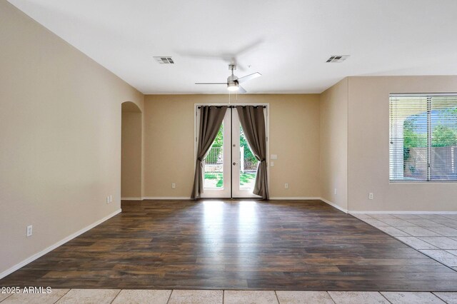 5726 W Park View Ln, Glendale, AZ 85310 - unfurnished room featuring a ceiling fan, wood finished floors, arched walkways, french doors, and baseboards