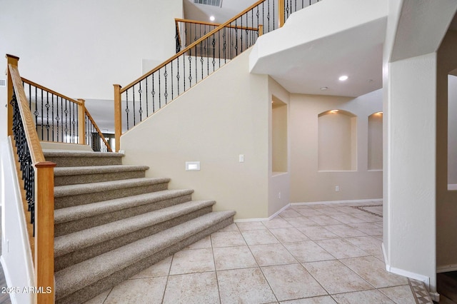 5726 W Park View Ln, Glendale, AZ 85310 - staircase featuring a high ceiling, tile patterned flooring, and baseboards