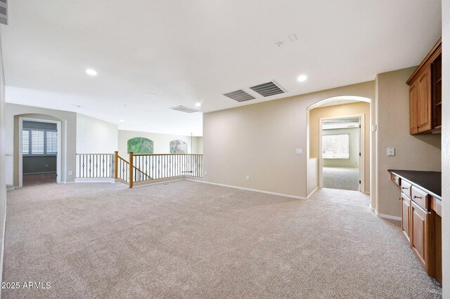 5726 W Park View Ln, Glendale, AZ 85310 - spare room with arched walkways, light colored carpet, baseboards, and recessed lighting