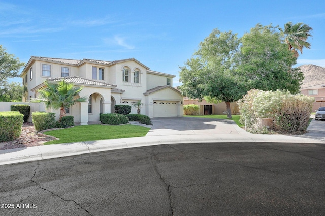 5726 W Park View Ln, Glendale, AZ 85310 - mediterranean / spanish-style home with stucco siding, concrete driveway, a tiled roof, and a garage